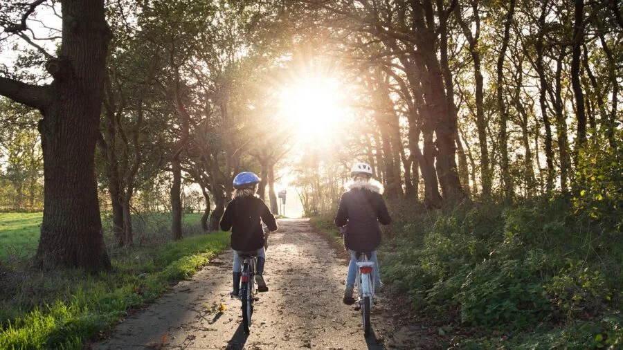Young child riding bicycle outdoors, demonstrating proper bike fit and growth during childhood activities