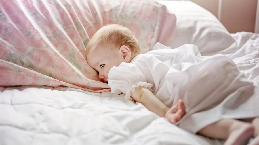 Young child sleeping soundly in cozy pajamas and bedding, demonstrating comfort and quality design