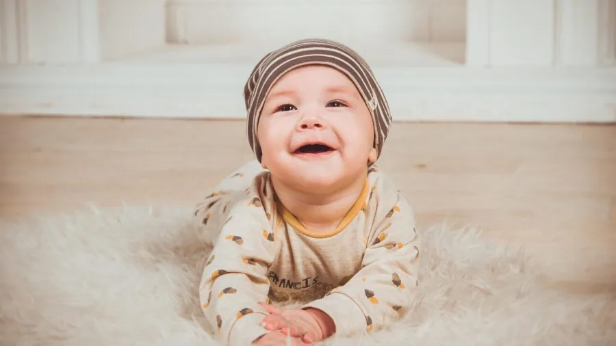 Young child standing and reaching upward, showing growth and development milestones