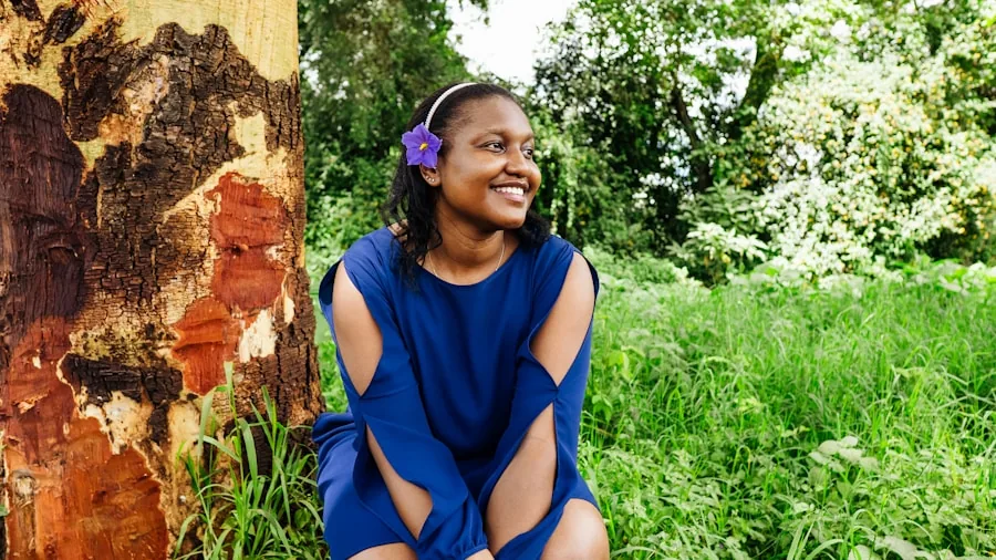 Young child wearing protective over-ear headphones while playing outside in natural daylight environment