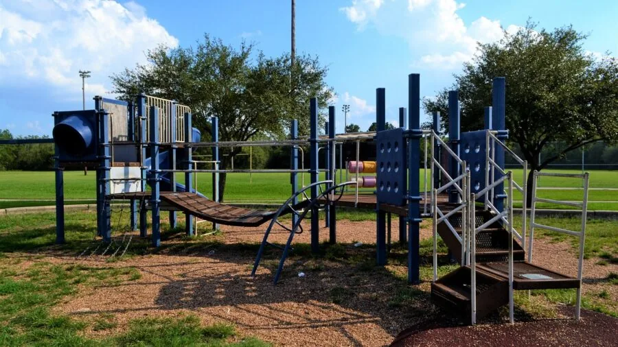 Young kids enjoying playtime on a slide in a bright, versatile play space suitable for indoor and outdoor use