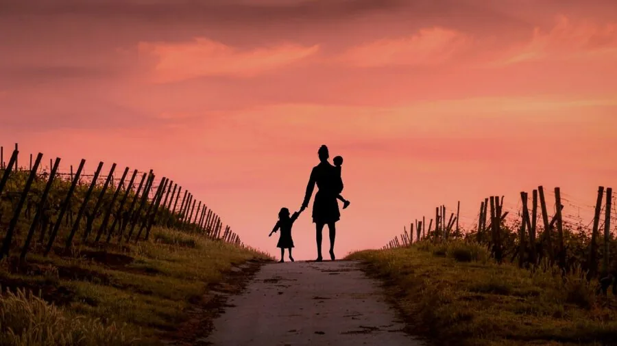 Young student carrying backpack walking to school outdoors in natural daylight